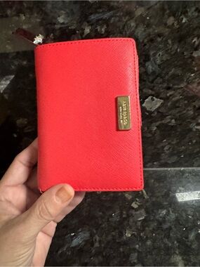 kate spade coral-red zip wallet with gold logo